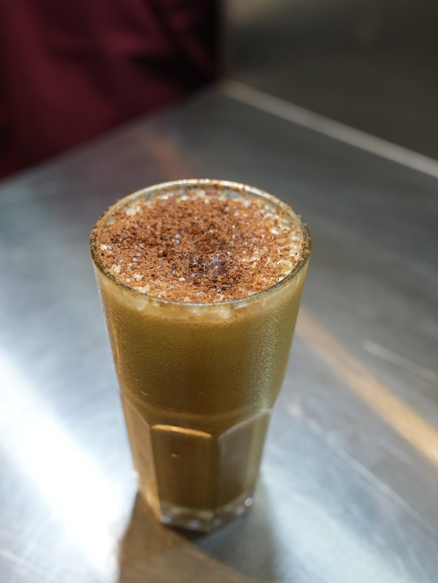 Cold coffee topped with cocoa powder